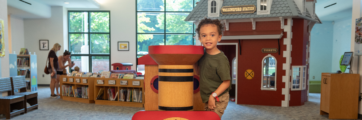 Child on train in WPL Preschool Room