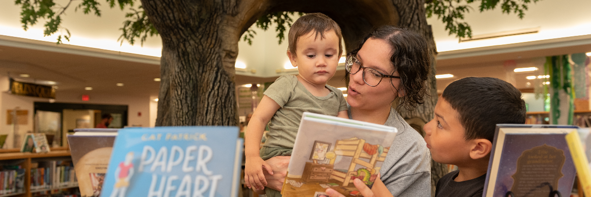 Mother with two children looking at a book