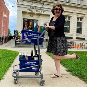 Readers' Advisory Librarian Cindy Haiken in front of the Library Wine Bar & Bistro