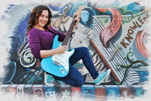 Woman playing electric guitar