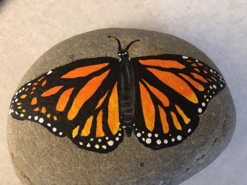 rock with monarch butterfly painted on it