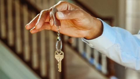 person holding a house key