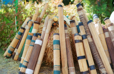 wooden rain sticks leaned up against a stump