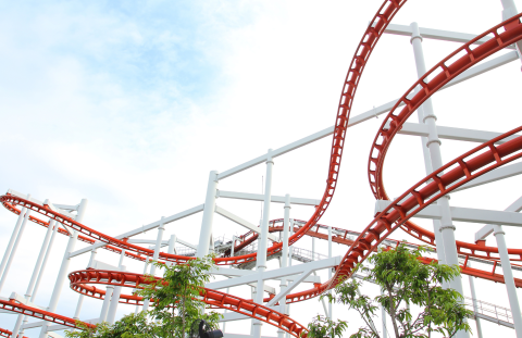 Image of a twisty red and white roller coaster