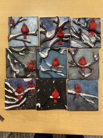 polymer clay relief of a cardinal on a snowy branch