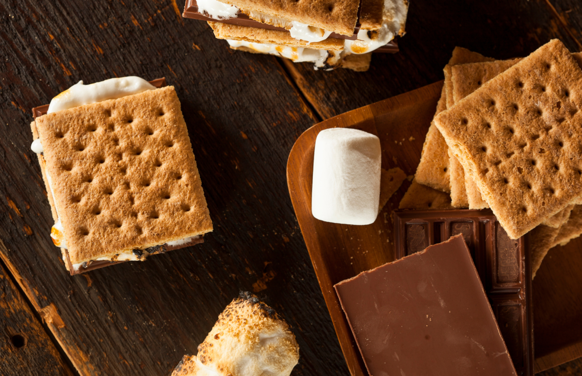 S'Mores atop a table, along with chocolate and marshmallows