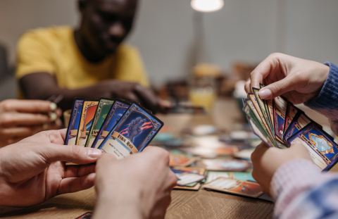 People holding various trading cards