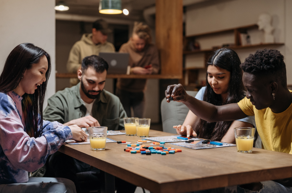 image of four adults playing a board game